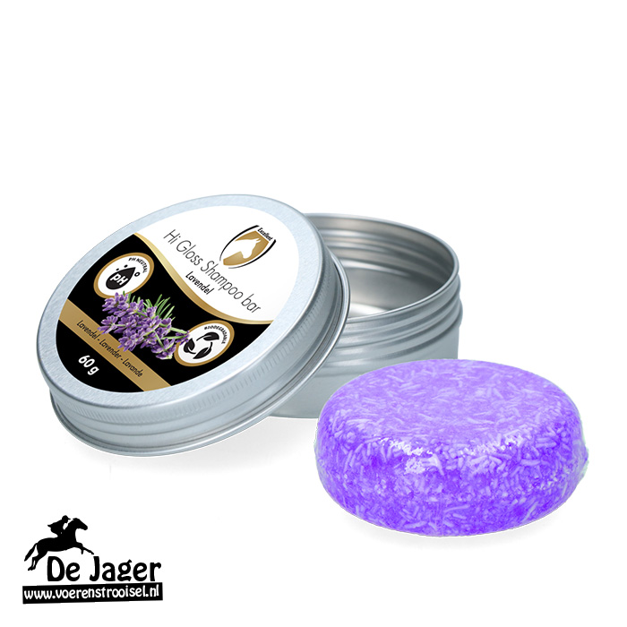 Lavender-scented solid shampoo bar in a metal tin, with the lid open and the purple bar beside it (De Jaer brand)
